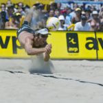 Fourth seeded Canyon Ceman helps playing partner Mike Whitmarsh by diving for the ball during their finals match against first seeded Dax Holdren and Eric Fonoimoana at the AVP 2002 Michelob Light Manhattan Beach Open Finals.  Danny Moloshok/Getty Images 
